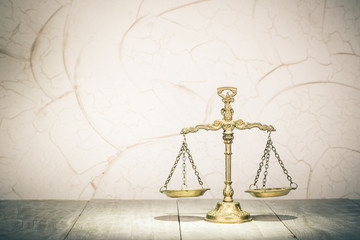 Retro law scales on table. Symbol of justice. Vintage style filtered photo
