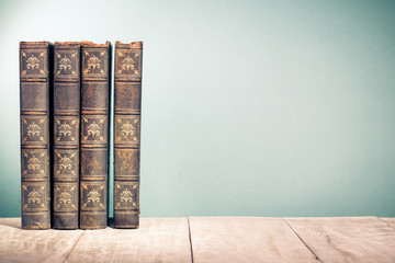 Vintage old books on wooden shelf. Retro style filtered photo