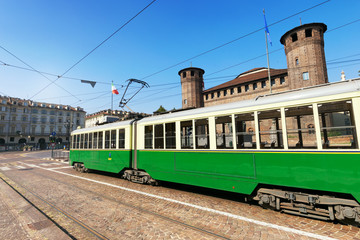 Fototapeta na wymiar Historical green tram in Piazza Castello, Turin, Italy