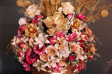 Artificial bouquet of flowers gold color