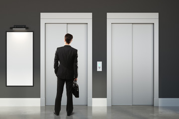 Fototapeta premium Thoughtful man in room with lift