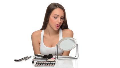 beautiful young female checking her facde skin