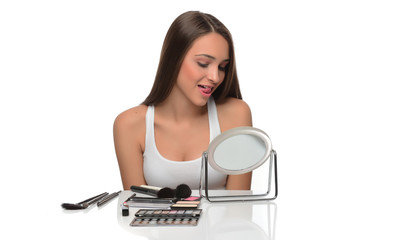 beautiful young female checking her facde skin