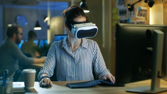 Beautiful Female Virtual Reality Engineer/ Developer Wearing VR Headset Creates Content. She Works in a Creative Designers Studio.Shot on RED EPIC-W 8K Helium Cinema Camera.