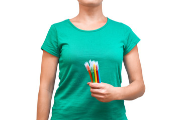 girl holding colored felt pens in her hand. Isolated on white background