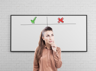 Pensive young businesswoman, pros and cons