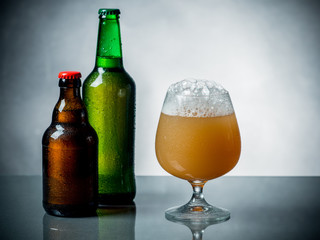 Composition of beer glass and some bottles