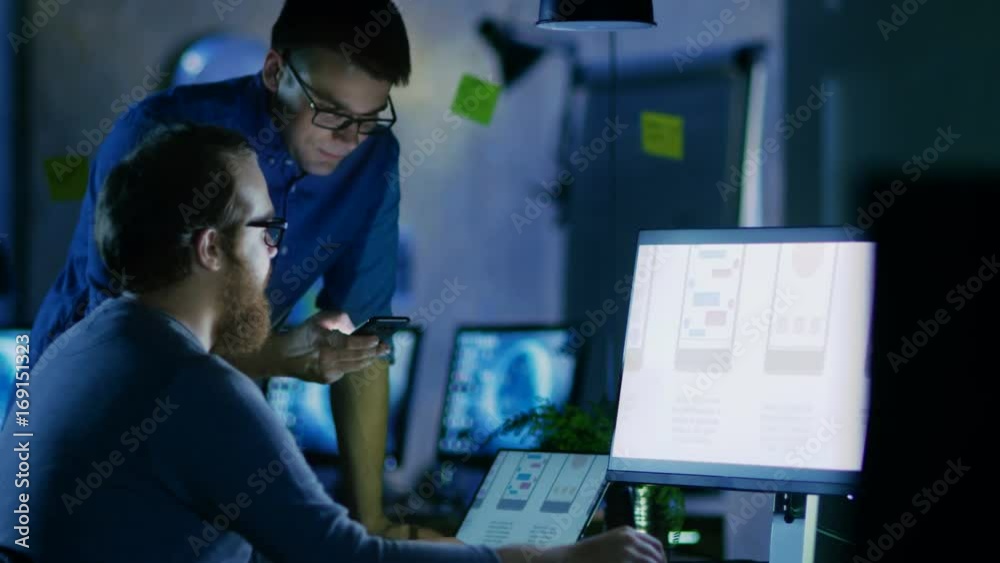 Aufkleber Two Male Mobile Application Developers Design and Create Quality Product. It's Late at Night They' the Only Ones Who are in the Office. Shot on RED EPIC-W 8K Helium Cinema Camera.