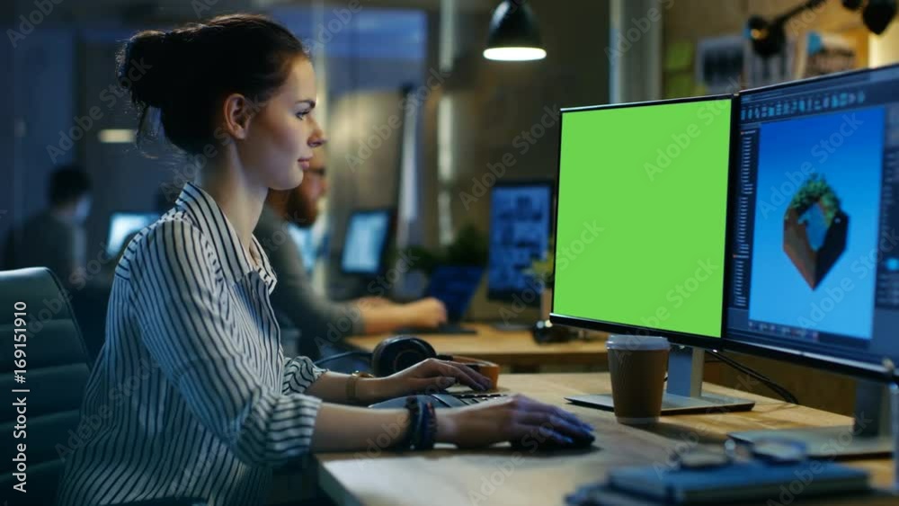 Poster beautiful female creative professional works on a personal computer with mock-up green screen, secon