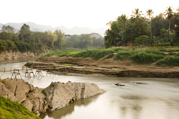 Bamboo bridge at the tip of the Luang Prabang peninsula. The bridge crosses over the Nam Khan River near where Nam Kham meets Mekong. Luang Prabang. Laos.