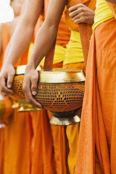 Monks processing for alms in the early morning, a 1,000-year old tradition in Luang Prabang, Laos..
