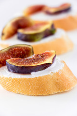 Sandwich Bruschetta with Fig and Goat Cheese on white background. Shallow depth of field. Selective focus, Closeup