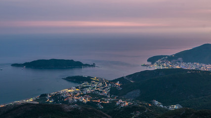 Evening skyline of coastline with Budva and Becici tourist resorts