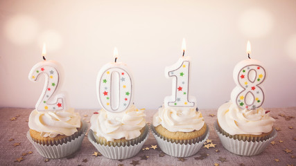 2018 Happy New Year Cupcakes with fairy light toning background