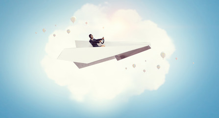 Woman pilot in paper plane. Mixed media