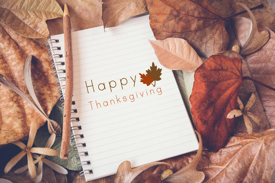 Happy Thanksgiving on Notebook with Autumn leaves