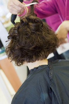 Stylist Combing Client's Hair at a Salon