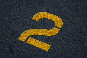 stenciled number 2 two in yellow paint on blacktop in parking lot - for use as background
