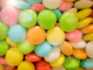 Fototapeta na wymiar abstract blur: colorful from mix of button shape chocolate candy