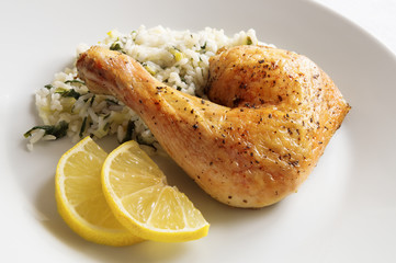roasted with herbs chicken leg on rice with chard and leek garnished with lemon