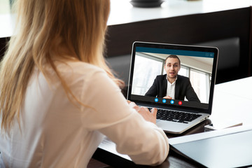 Fototapeta na wymiar Businesswoman making video call to business partner using laptop, looking at screen with virtual web chat, contacting client by conference, talking on webcam, online consultation, hr concept, close up