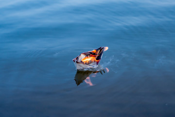Fototapeta premium The paper boat burns
