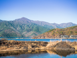 landscape view from kawaguchi lake with bridge , town and mountain background (soft focus) from japan