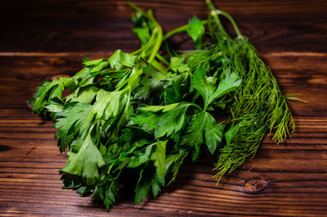 Bunch of parsley and dill on wooden table