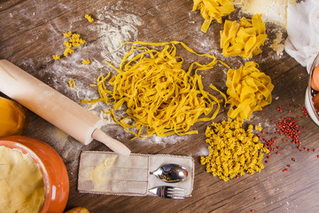 Top view of a kitchen table with different kinds of pasta.