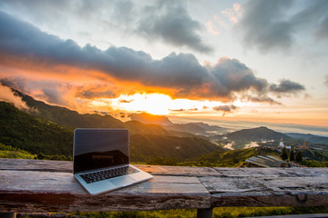 Freelancer office in mountain cafe. Online webinar everywhere via 4ginternet with mountain and sunrise background.