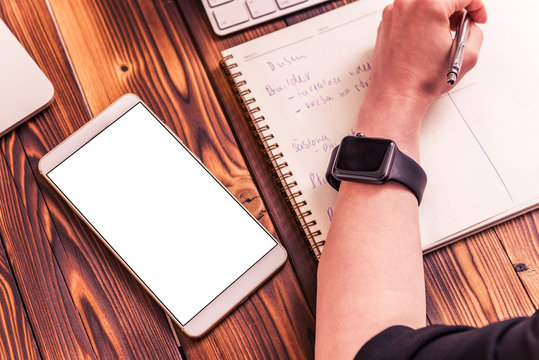 Mockup - Smartphone on wooden board and smartwatch on woman's hand - Powered by Adobe