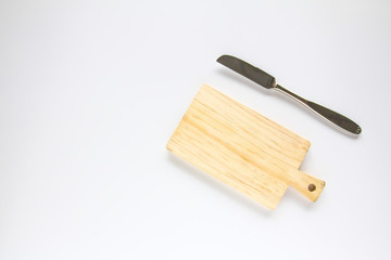 Wooden chopping board and knife on white background