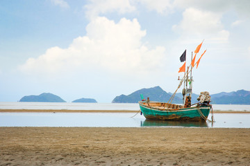 Naklejka na ściany i meble Fishing boats parked on the shore