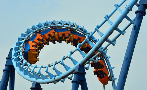  Roller Coaster  Ride Filled  With Thrill Seekers Doing Corkscrew.