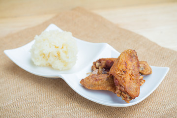 Fried chicken wings and crispy garlic with sticky rice(selective focus)