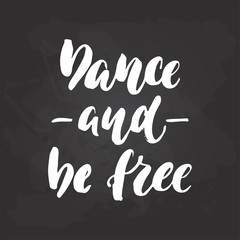 Dance and be free - lettering dancing calligraphy quote drawn by ink in white color on the black chalkboard background. Fun hand drawn lettering inscription.
