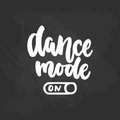 Fototapeta premium Dance mode On- lettering dancing calligraphy quote drawn by ink in white color on the black chalkboard background. Fun hand drawn lettering inscription.