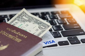 Passport and money on the keyboard