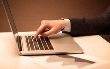 Businessman is suit working on laptop