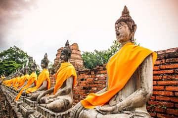 aligned buddha statues at Wat Yai Chai Mongkhon Ayutthaya - obrazy, fototapety, plakaty