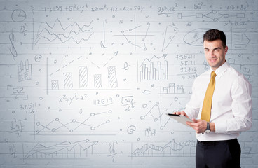 Salesman standing with drawn graph charts