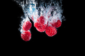 Raspberry s splashing in a clear water