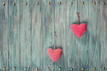 Two love hearts on wooden vintage background. Retro style filtered photo