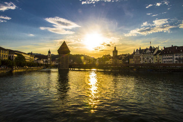 TOP OFF ATTRACTION IN SWITZERLAND. LUCERNE OLD WOOD CHAPEL BRIDGE IN SUMMER SUNSET LIGHT