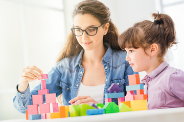 Fototapeta premium Mother and child playing together at home
