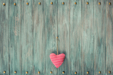 Valentine love heart on vintage old grunge textured planks wall background. Retro style filtered photo