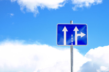 european traffic sign white arrows on blue background