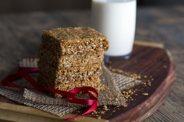 Stack of oatmeal crunchy cookies and milk in background
