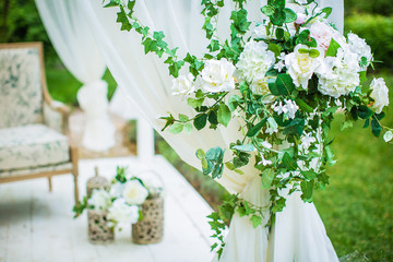 flowers roses bound on a white curtain on the background alcove in nature