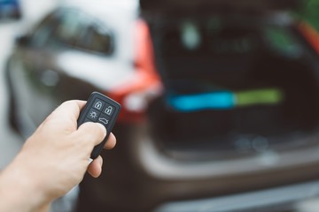 Man opening or closing car trunk